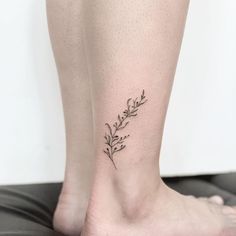 a woman's foot with a small floral tattoo on her left side calfocks