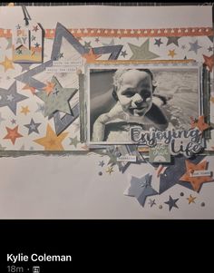 a scrapbook page with an image of a baby's face and stars on it