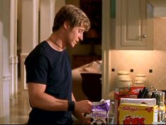 the young man is preparing food in the kitchen