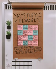 a bulletin board with words written on it and a potted plant next to it