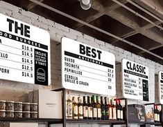 the menus are hanging on the wall above the counter in the restaurant's bar