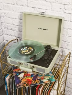 a record player sitting on top of a stack of records