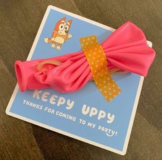 a pink bow with polka dots on it and a card that says, keep uppy thanks for coming to my party