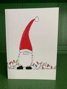 a card with a drawing of a santa clause on it