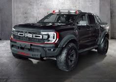 a black truck with red lights on it's hood and tires is parked in a garage