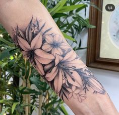 a woman's arm with flowers on it