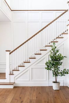 a white staircase with a potted plant next to it and the words, how to decorate