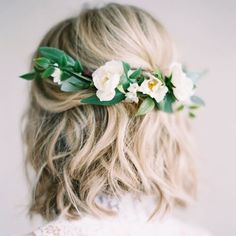 a woman with blonde hair wearing a flower crown