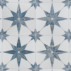 an artistic blue and white tile design with stars on the bottom, in various sizes