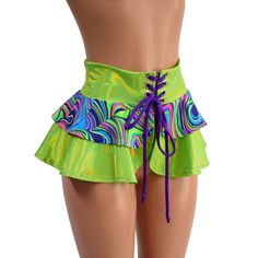 "This is the shortest version of our tiered double ruffle skirt! This 10\" long circle cut skirt has a lace-up at the waistband, and a tiered ruffle, for double the cuteness. The waistband and longer ruffle are made from Neon Lime Holographic, and the short ruffle is Glow Worm.  The laceup tie is Grape holographic. Perfect for matching with our cheekies, shorts and crops, or wear it over leggings The skirt is open below the laceup, so be sure to wear something cute underneath! (or not? ;) ) This Green Ruffled Skirted Skort, Green Ruffled Skort, Ruffled Bottoms For Summer Costume Party, Green Tiered Skirt Skort With Ruffles, Green Tiered Ruffle Skort, Green Ruffled Mini Skort, Fun Fitted Party Bottoms, Green Tiered Ruffles Mini Skirt, Green Tiered Skirt For Party