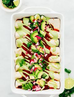 an entree with avocado, radishes and cilantro in a white casserole dish