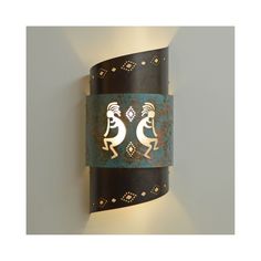 a decorative wall light with an image of two people dancing on it's side