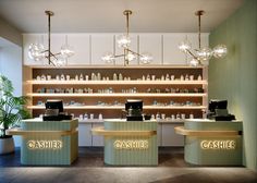 the interior of a cashier store with lights and counter tops in front of it