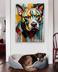 a dog is laying in his bed on the floor next to a wall with a painting