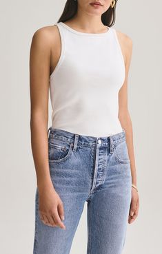 a woman wearing jeans and a tank top