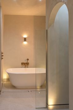 a white bath tub sitting inside of a bathroom