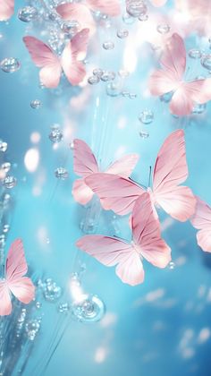 pink butterflies floating in the air with bubbles and water around them on a blue background