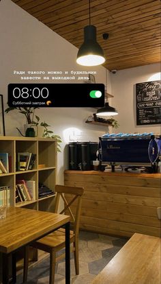 a restaurant with wooden tables and chairs in front of a menu board on the wall