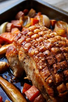 a close up of meat and vegetables in a pan