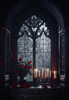 a bunch of candles that are sitting in front of a window with roses on it