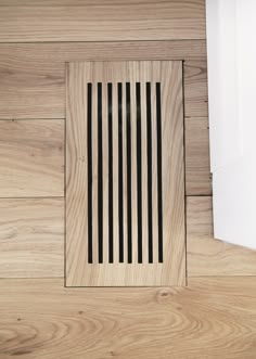 a wooden floor with a vent on it