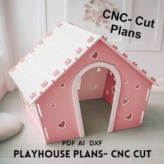 a pink and white dog house with hearts on it