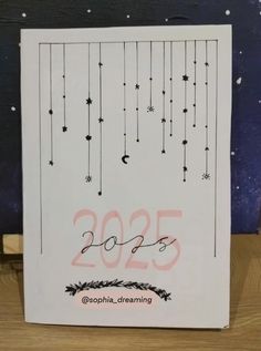 a white card with the numbers 2055 and stars hanging from it's sides