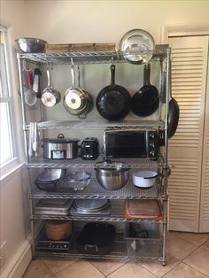 the shelves are filled with pots and pans