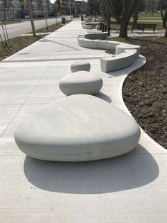 This picture is packed full of precast goodness. Our Watari bench coupled with our Galet and Cloud seating, bring some movement to this high traffic area. Concrete Street Furniture, Architecture Public Space, Urban Furniture Bench, Bench Concrete, Cement Kitchen, Granite Furniture, Terraced Landscaping, Architectural Concrete