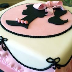 a pink and black cake on a table