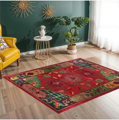 a living room with green walls and wooden flooring has a red rug on the floor