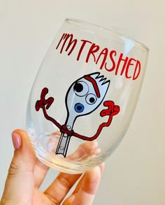 someone holding up a wine glass with the words i'm trashed on it