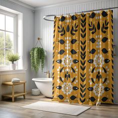 a yellow shower curtain with black and white flowers on it in front of a bathtub