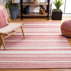 a pink and white striped rug in a living room