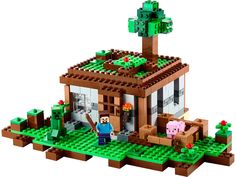 a small house made out of legos with animals on the roof and trees in front