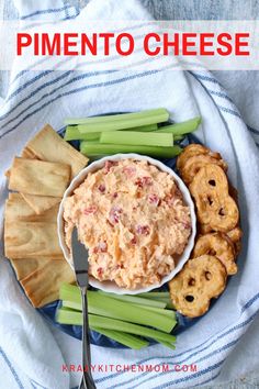 a plate with celery, crackers and dip on it next to chips