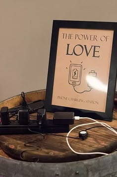 the power of love is displayed in a frame on top of a barrel with other items