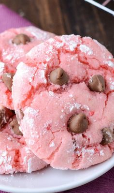 pink cookies with chocolate chips on a white plate