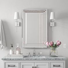 a bathroom vanity with two sinks and a large mirror