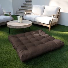 a living room filled with furniture on top of green grass