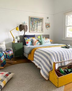 a bed room with a neatly made bed next to a dresser and chair in it