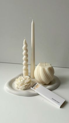 a white candle and some other items on a table