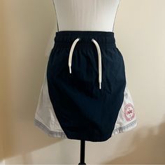 Vintage Nike Logo Tennis Skirt With A Navy Center And White Diagonal Details. Elastic Waistband And Stiffer Fabric (Beneficial For Not Having To Worry About Your Skirt Lifting Constantly). 100% Nylon #Vintagenike #Tennisskirt #Athletic Navy Sporty Skort For Summer, Navy Cotton Summer Skirt, Casual Navy Lined Skort, Navy Casual Skort Short Length, Casual Navy Skort With Lined Skirt, Navy Casual Short Length Skort, Nike Sporty Short Skirt, Navy Stretch Casual Skort, Sporty Cotton Skirt For Summer