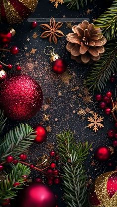 christmas decorations and pine cones on a black background