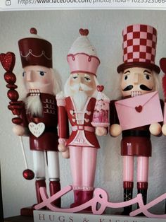 three nutcrackers are standing next to each other in pink and red outfits