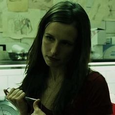 a woman holding a knife and fork in her hand