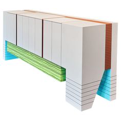 a white cabinet with colorful strips on the bottom and sides, against a white background