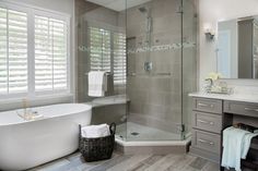 a bath room with a tub a sink and a mirror