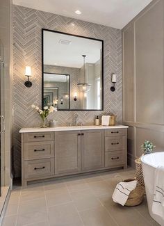 a bathroom with a tub, sink and mirror in it's centerpieces