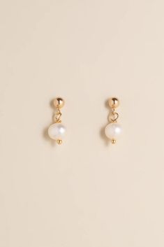 Elegant, minimal and beautiful, the Circe pearl drop are a timeless yet stylish pair of earrings, that will match any outfit and elevate your already amazing style. *Due to the unique nature of the pearls, the colors and shapes may vary slightly from the picture shown. Details: Material: 14k gold-filled Handcrafted Gemstone: Natural baroque pearl Hypoallergenic and Tarnish resistant Water Resistant Minimalist Pearl Earrings For Pierced Ears, Minimalist Pearl White Pearl Chain Earrings, Minimalist Pearl Drop Earrings, Formal Minimalist Pearl Earrings With Charm, Classic Pearl Pendant Earrings In 14k Gold Filled, Minimalist Pearl Earrings With Charm, White Minimalist Pearl Pendant Earrings, Minimalist White Pearl Pendant Earrings, Minimalist White Earrings With Pearl Pendant